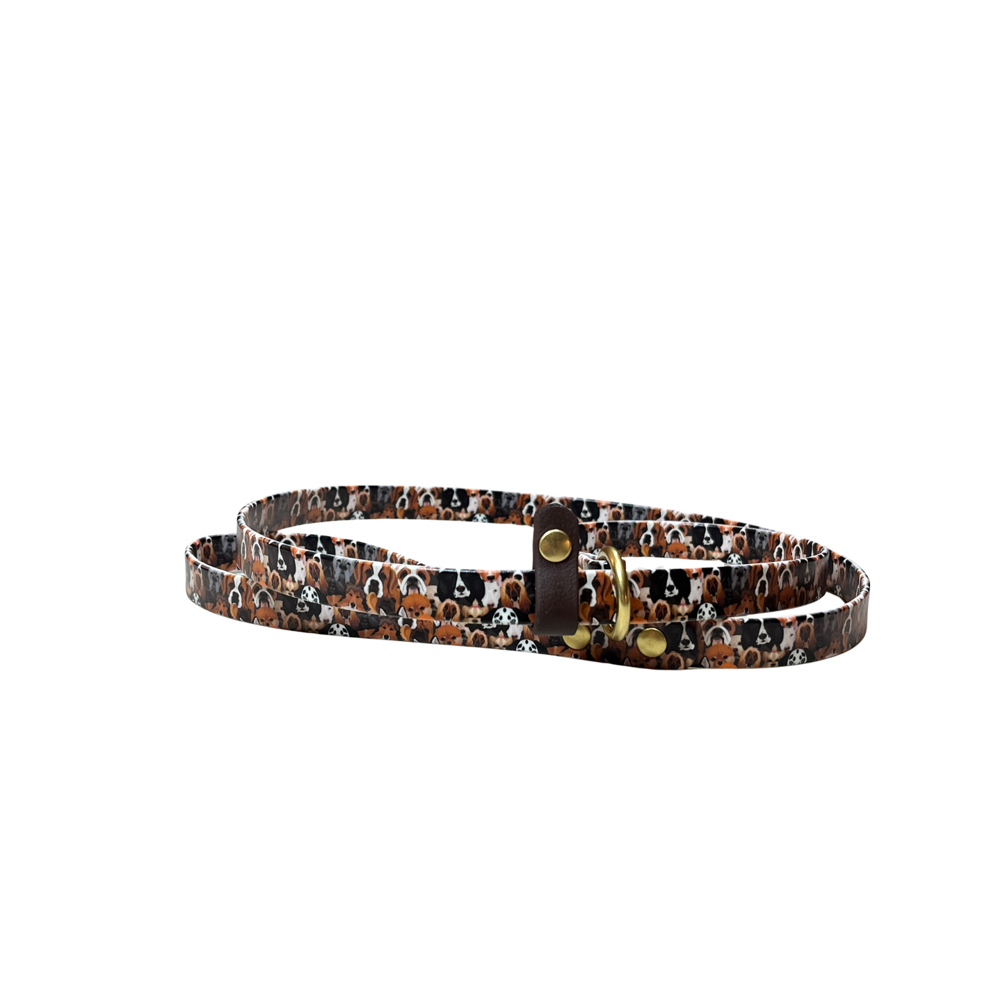 A coiled  BioThane Slip Lead featuring a repeat pattern of multiple dog breeds in black, white, and tones of brown. The slip lead has a stop, brass O-rings and rivets, and is shown on a plain white background. 