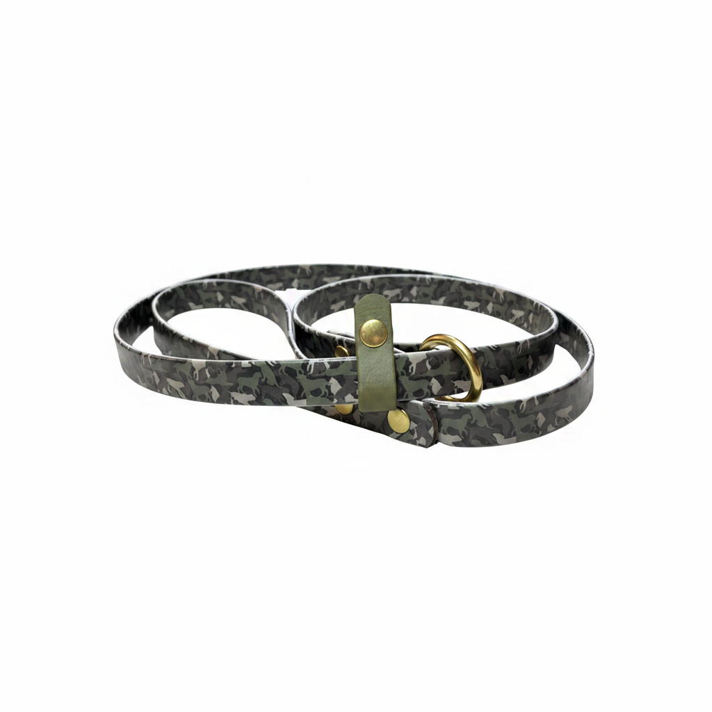 A BioThane Slip Lead with a printed camouflage pattern of dog silhouettes in olive, gray and brown, with coordinating stop in olive. Slip lead has brass O-ring and rivets. 