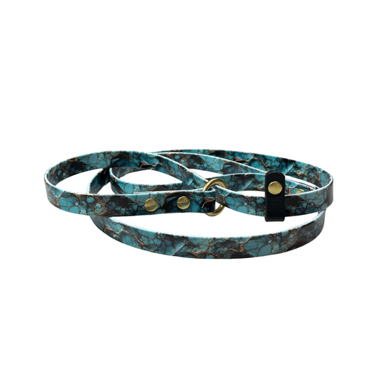 BioThane Slip Lead with UV printed turquoise marble pattern with accents in gold. Slip Lead has brass O-ring, rivets, and black stop. The lead is coiled with a white background.